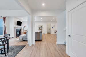 Hallway featuring light wood-type flooring, recessed lighting, and stairs