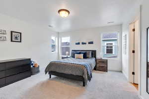 Carpeted bedroom featuring baseboards