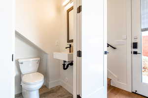 Bathroom with baseboards and toilet
