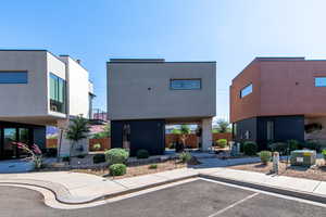View of building exterior featuring uncovered parking