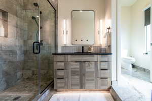 Full bath with a stall shower and vanity