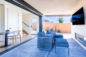 View of patio with an outdoor living space with a fireplace