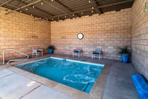 Indoor pool featuring a patio area