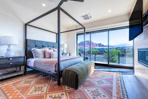 Bedroom featuring wood finished floors, access to outside, and recessed lighting