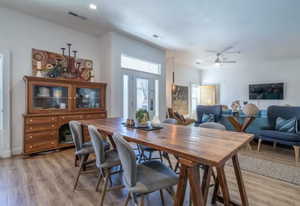 Dining space featuring light wood-style floors, a ceiling fan, and recessed lighting