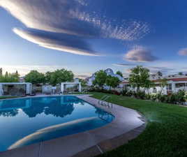 View of swimming pool with a yard and a patio