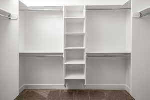 Walk in closet with carpet floors