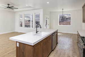 Kitchen featuring stainless steel appliances, light wood-type flooring, a chandelier, light countertops, and recessed lighting