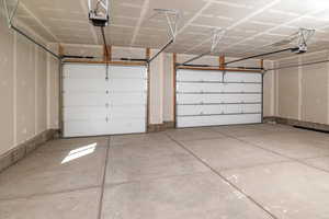 Garage featuring a garage door opener