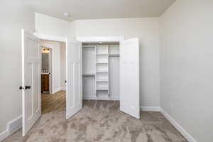 Unfurnished bedroom with carpet flooring and a closet