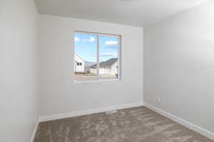 Unfurnished room with carpet flooring and baseboards