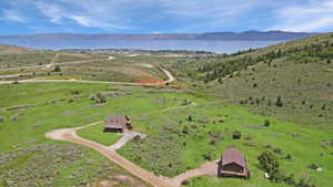 Aerial view of property's location featuring a water and mountain view