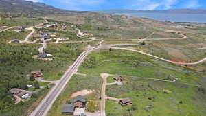 Aerial view of property and surrounding area featuring a water and mountain view