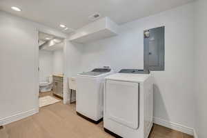 Washroom with electric panel, washer and dryer, and recessed lighting