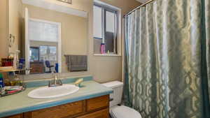 Bathroom featuring vanity, curtained shower, and connected bathroom