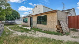 Back of house featuring a trampoline
