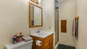 Full bath featuring vanity and an enclosed shower