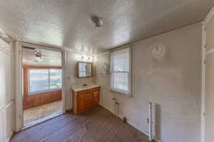 Bathroom featuring a textured ceiling and vanity
