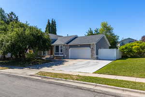 View of front of house featuring a garage, a shingled roof, and concrete driveway