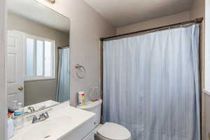 Bathroom with vanity and curtained shower