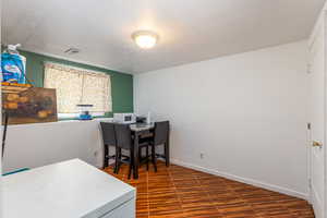 Office area with baseboards and a textured ceiling