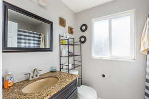 Full bath featuring vanity and toilet