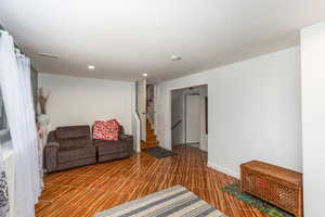 Living room with stairway and recessed lighting