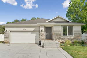 View of front facade with stone siding and stucco siding