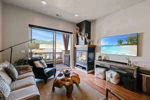 Living room featuring hardwood / wood-style flooring and recessed lighting