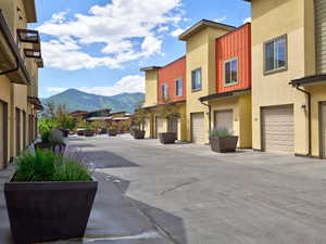 View of heated drive featuring private community patio with a mountain view