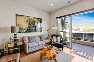 Living room with a mountain view, wood finished floors, and recessed lighting