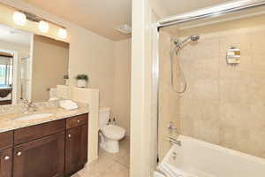 Bathroom featuring vanity, tile patterned flooring, and tub / shower combination