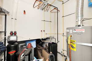 Utility room featuring water heater