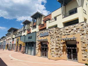 View of Townhome exterior upper deck with Newpark Shops below