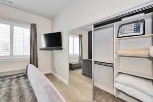 Furnished bedroom featuring items for Nightly rental with light carpet and baseboards