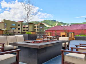 View of private patio  with a mountain view and an outdoor living space with a fire pit