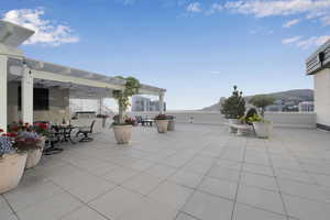 View of patio / terrace with a pergola, a mountain view, and outdoor dining space