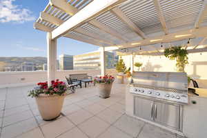 View of patio / terrace with grilling area, a pergola, and a mountain view