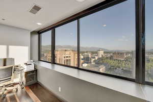 Office area with a mountain view, wood finished floors, and plenty of natural light