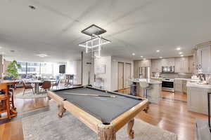 Playroom featuring light wood finished floors, pool table, and recessed lighting