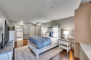 Bedroom with wood finished floors and ensuite bath