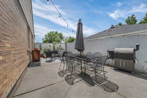 View of patio / terrace featuring outdoor dining space and a grill