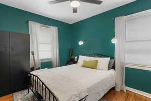 Bedroom with wood finished floors and a ceiling fan