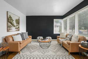 Living area with wood finished floors and baseboards