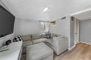 Living room with light wood-style flooring and baseboards