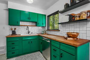 Kitchen with wood counters, open shelves, and decorative backsplash