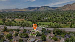Aerial view of residential area featuring mountains and property boundaries highlighted