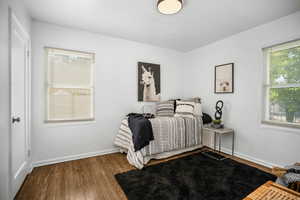 Bedroom featuring wood finished floors and baseboards
