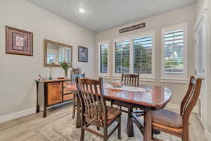Dining space featuring baseboards, light wood-style floors, and recessed lighting