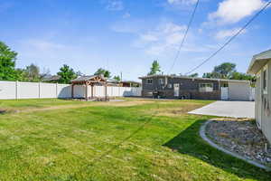 Fenced backyard with a gazebo and a patio area